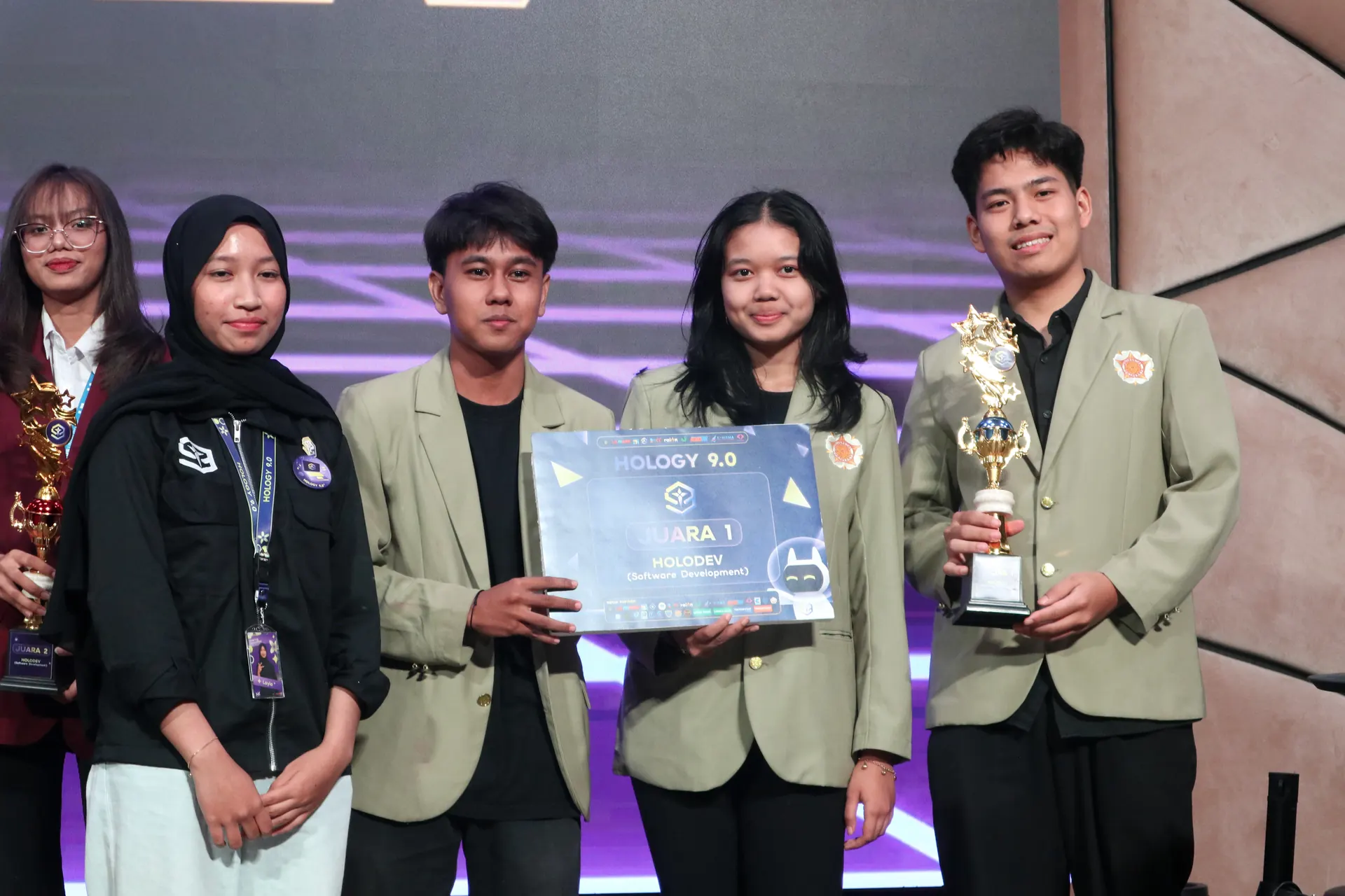 Team Hematrix holding the Juara 1 board and trophy
