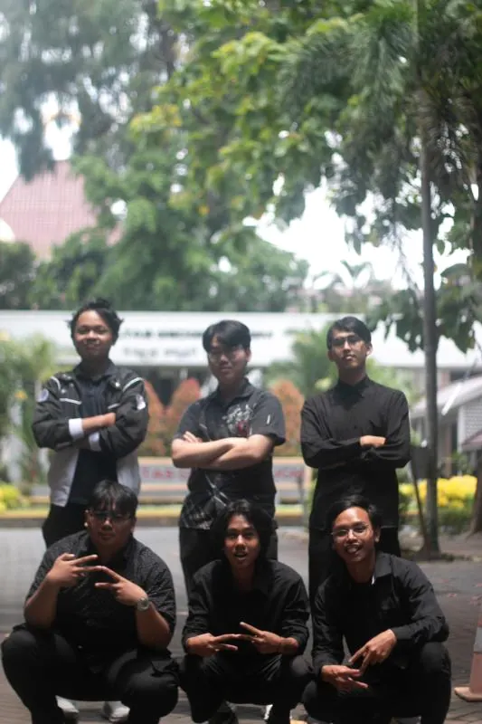 The KOMATIK Software Research and Development team posing outdoors in black