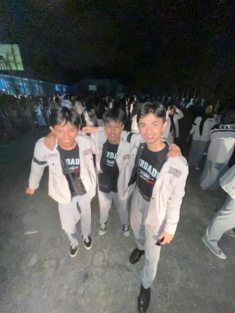 Azril with his closest high-school friends at night